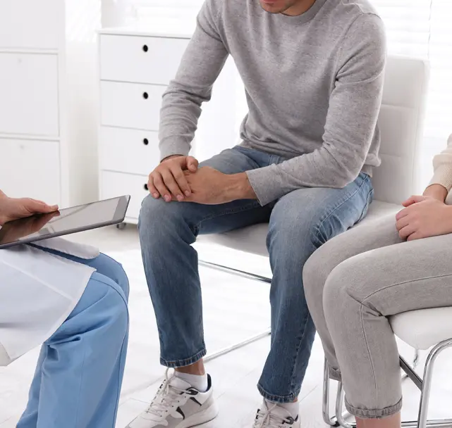 Person sitting and talking to his physician